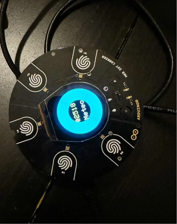 The round Meteo weather station from above, a glowing blue screen at its centre and touch pads around it.