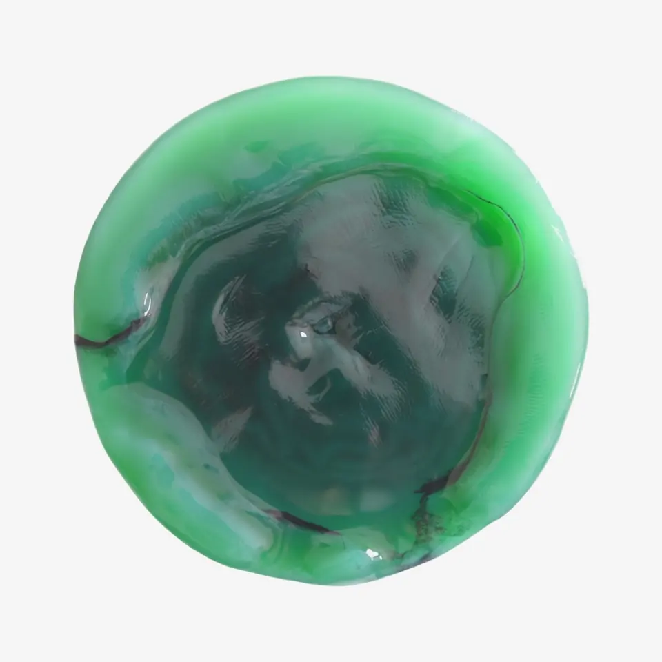 A wet, glossy disc of film, bright green at the rim and dark green in the middle.
